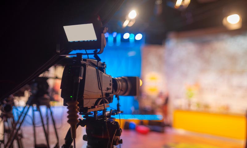 A film grade camera pointed at a dressed stage